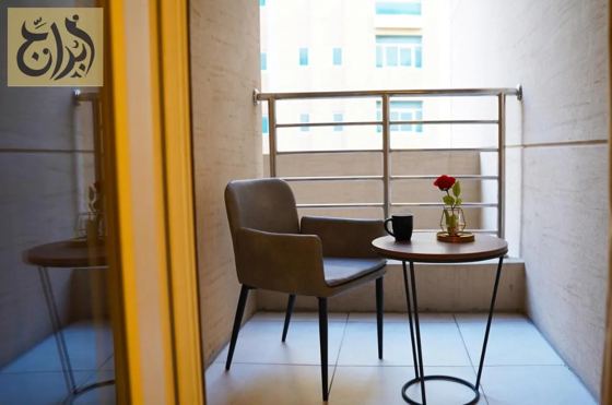 Balcony seating with table and chair in a suite at Abraj Suites Hotel, Al Mansoura, Doha