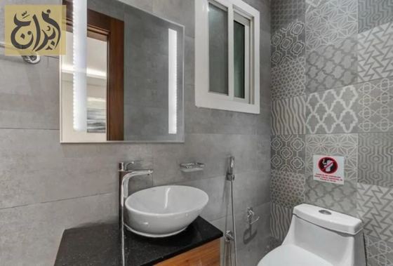 Guest bathroom with washbasin in a one-bedroom suite at Abraj Suites Hotel Doha