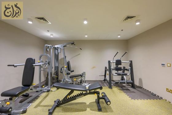 Fitness gym with strength equipment at Abraj Suites Hotel, Al Mansoura, Doha