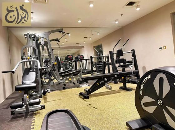 Fitness gym with strength training equipment at Abraj Suites Hotel Doha