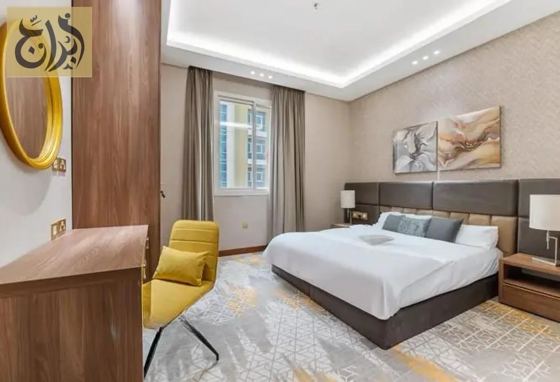 Master bedroom with king bed in a one-bedroom suite at Abraj Suites Hotel Doha