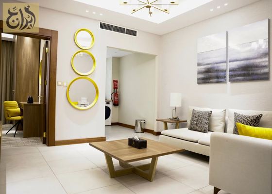 Separate living room in a one-bedroom apartment at Abraj Suites Hotel Doha