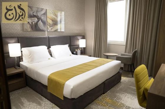 Master bedroom with king size bed in a one-bedroom suite at Abraj Suites Hotel Doha