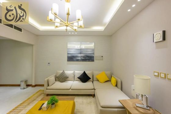 Living and dining area in a one-bedroom serviced apartment at Abraj Suites Hotel Al Mansoura Doha