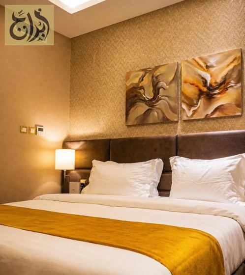 Suite bedroom with twin bed configuration at Abraj Suites Hotel Doha