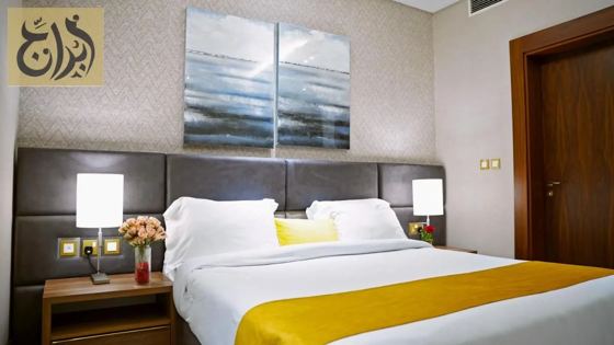 King bed suite bedroom with city view at Abraj Suites Hotel Doha