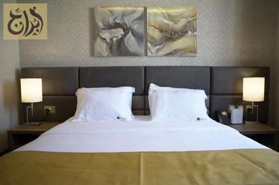 King bed in a one-bedroom suite at Abraj Suites Hotel, Al Mansoura, Doha