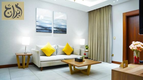 Living room with sofa and coffee table in a furnished apartment at Abraj Suites Hotel Doha