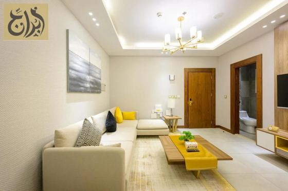 Separate living room with sofa and coffee table in a one-bedroom suite at Abraj Suites Hotel Doha